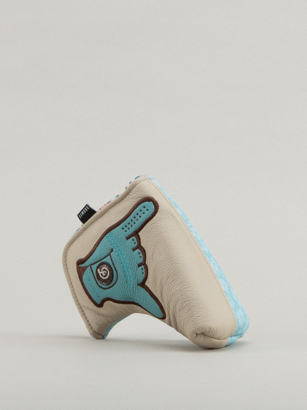 Beige and blue golf club headcover with a glove holding the shaka up