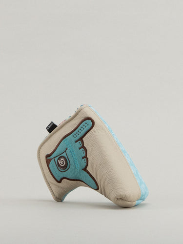 Beige and blue golf club headcover with a glove holding the shaka up