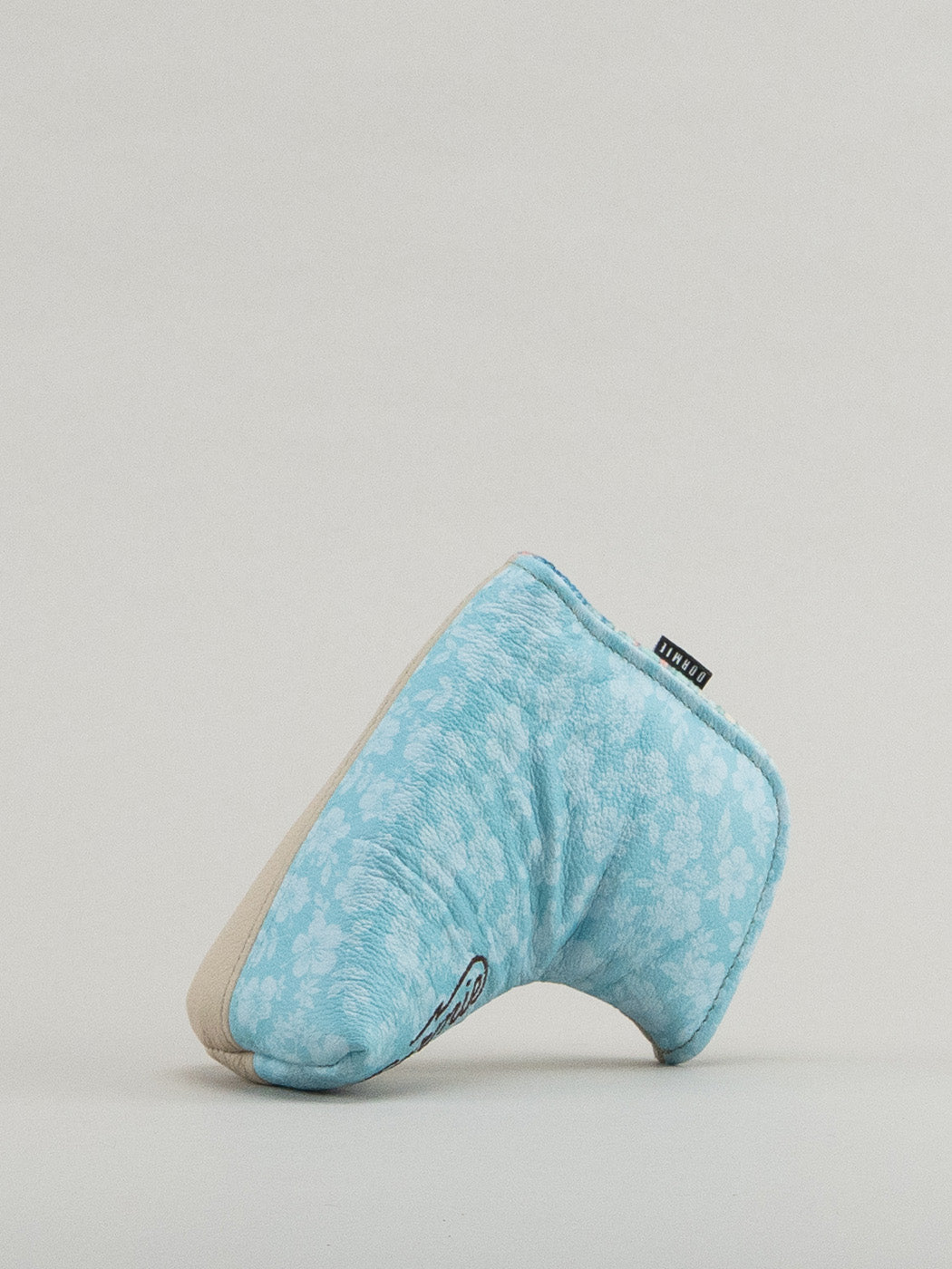 Beige and blue golf club headcover with floral print pattern showing